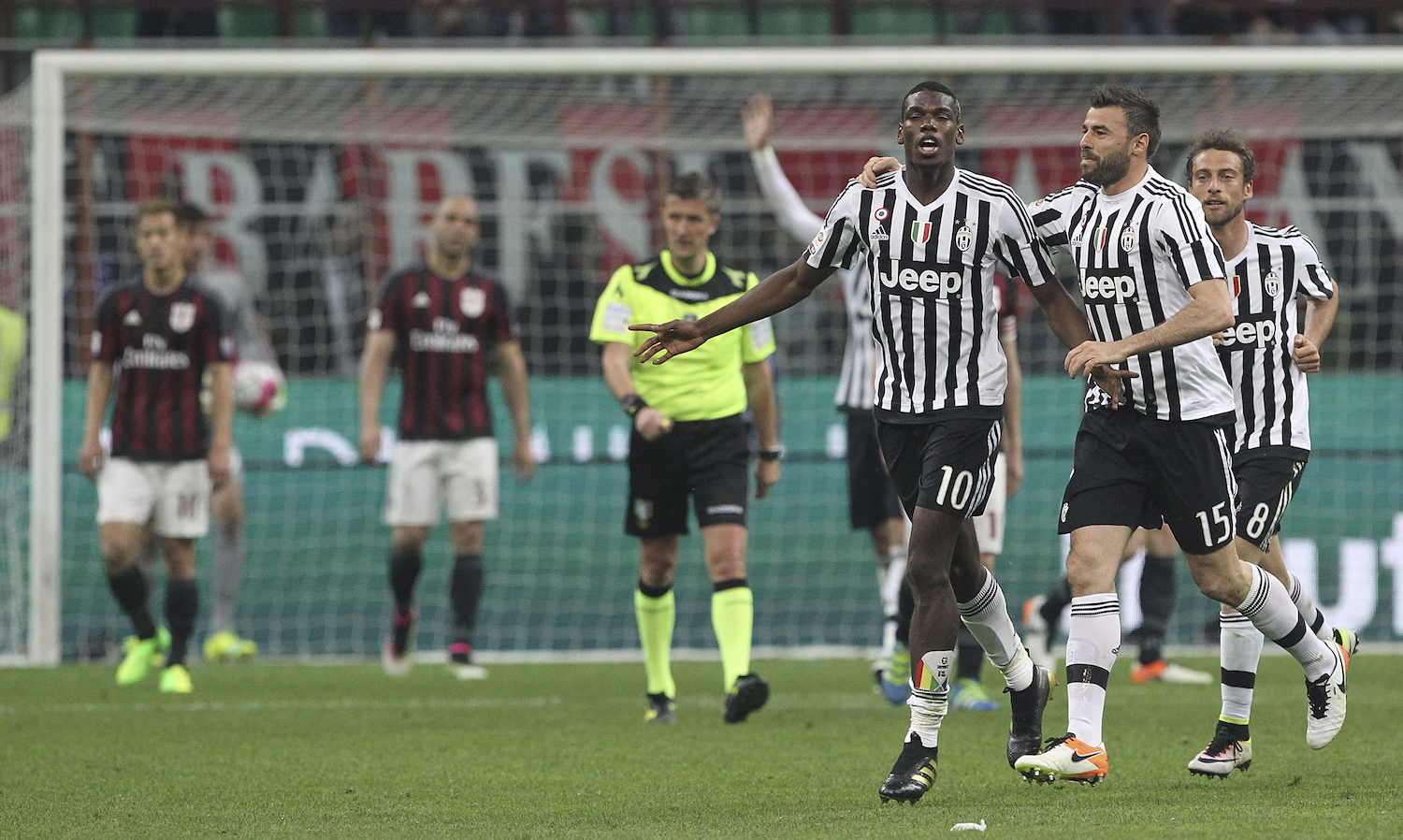 Pogba celebrates his goal as Milan players look on (Photo by Marco Luzzani/Getty Images)