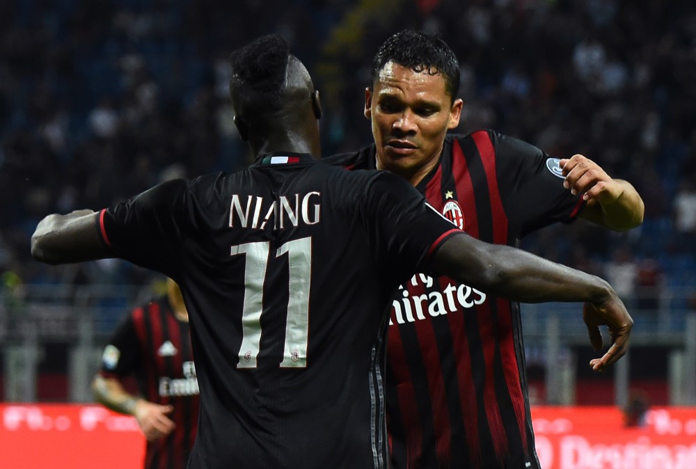 AC Milan's French forward Mbaye Niang celebrates with AC Milan's Colombian forward Carlos Bacca (R) after scoring a goal during the Italian Serie A football match between AC Milan and SS Lazio at the San Siro Stadium in Milan, on September 20, 2016. / AFP / GIUSEPPE CACACE (Photo credit should read GIUSEPPE CACACE/AFP/Getty Images)