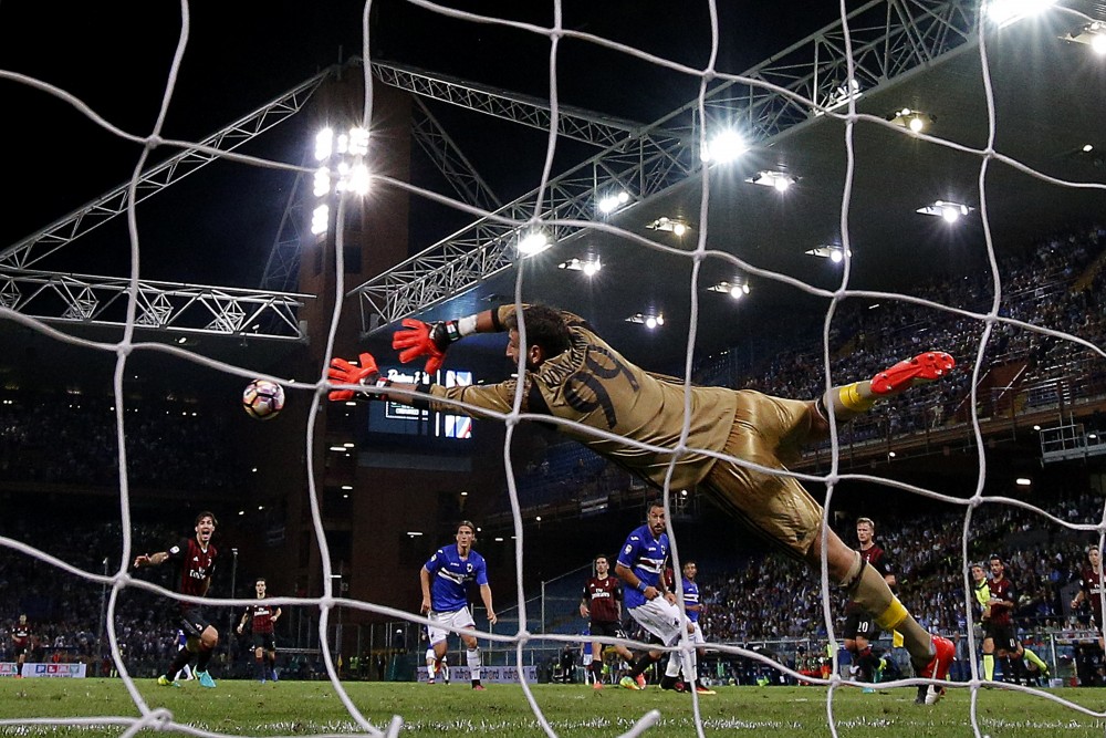 AC Milan's goalkeeper Gianluigi Donnarumma tries to block the ball during the Italian Serie A football match between Sampdoria and AC Milan on September 16, 2016 at 'Luigi Ferraris Stadium' in Genoa. / AFP / MARCO BERTORELLO (Photo credit should read MARCO BERTORELLO/AFP/Getty Images)