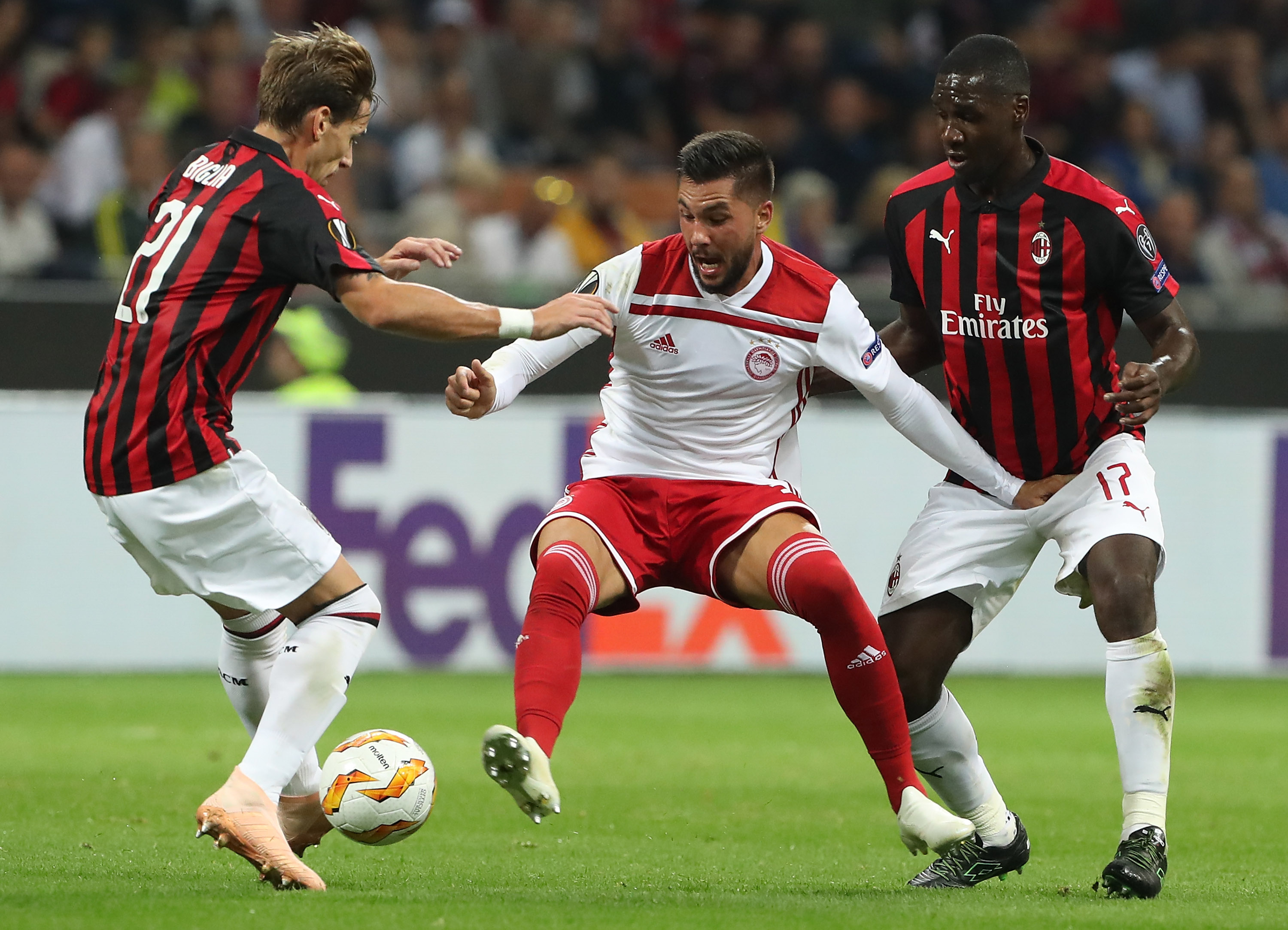 MILAN, ITALY - OCTOBER 04: Miguel Angel Guerrero (C) of Olympiacos FC competes for the ball with Cristian Zapata (R) and Lucas Biglia (L) of AC Milan during the UEFA Europa League Group F match between AC Milan and Olympiacos at Stadio Giuseppe Meazza on October 4, 2018 in Milan, Italy. (Photo by Marco Luzzani/Getty Images)