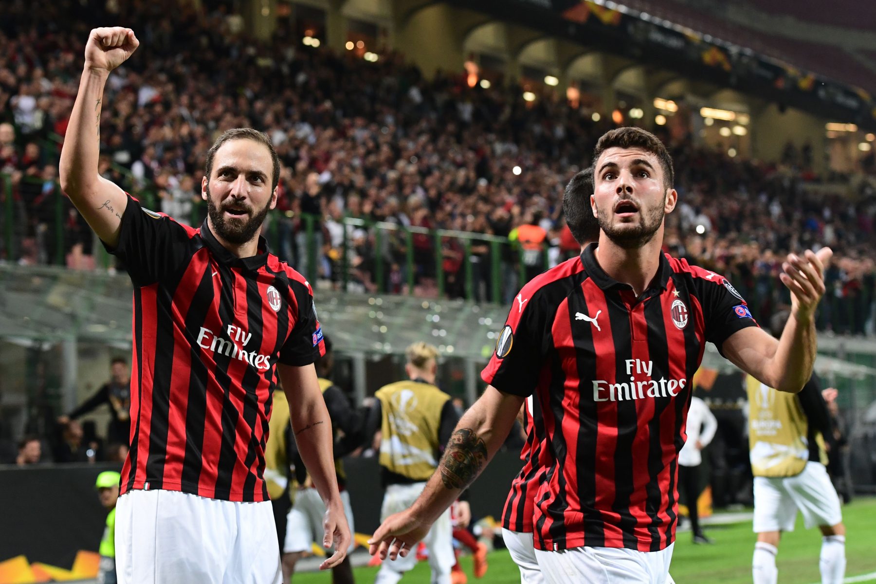 AC Milan's Argentine forward Gonzalo Higuain (L) and AC Milan's Italian forward Patrick Cutrone celebrate after Higuain scored during the Europa League Group F football match between AC Milan and Olympiakos at the San Siro stadium on October 4, 2018 in Milan. (Photo by Miguel MEDINA / AFP) (Photo credit should read MIGUEL MEDINA/AFP/Getty Images)