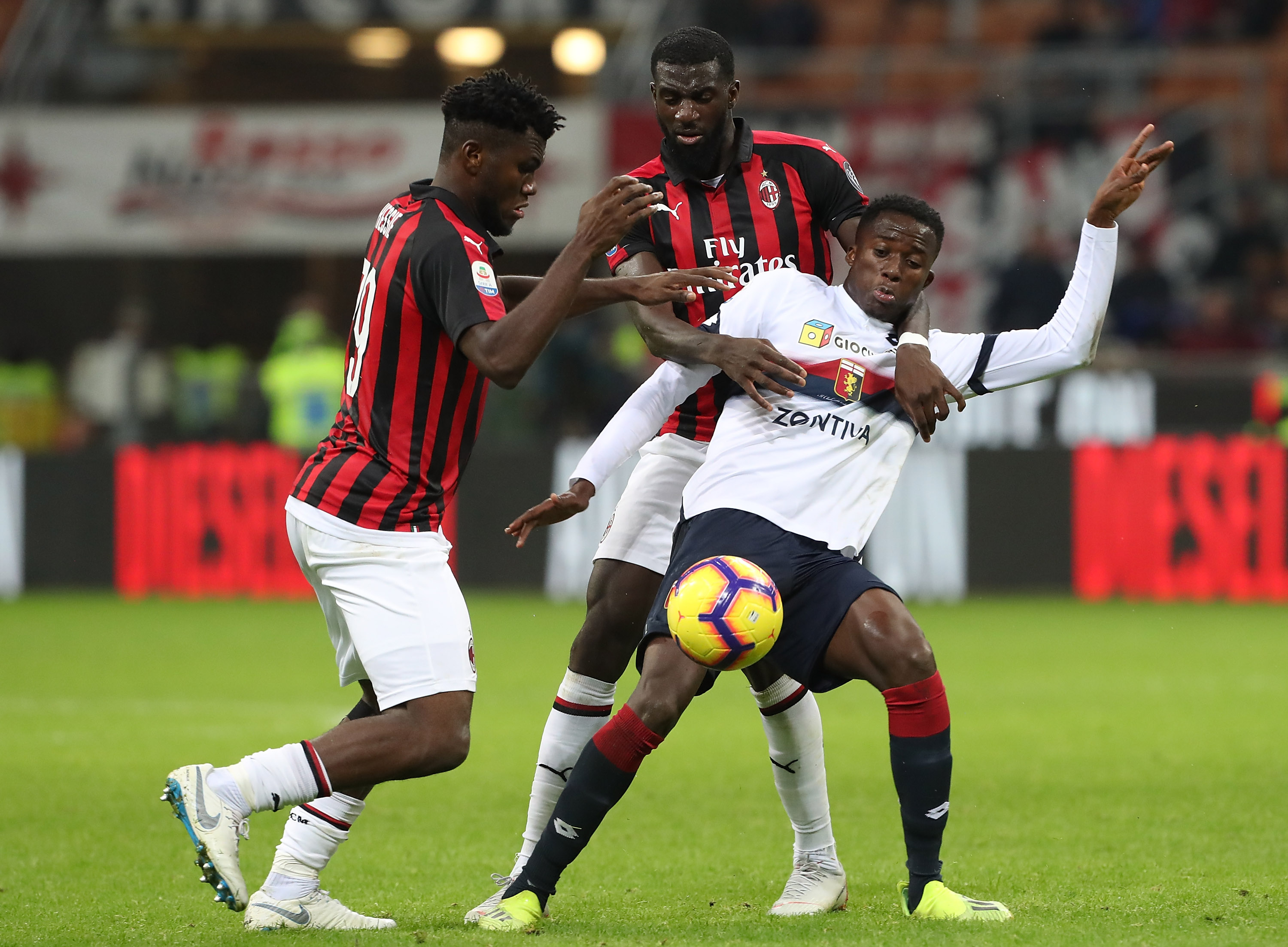 MILAN, ITALY - OCTOBER 31: Christian Kouame of Genoa CFC competes for the ball with Tiemoue Bakayoko and Franck Kessie (L) of AC Milan during the serie A match between AC Milan and Genoa CFC at Stadio Giuseppe Meazza on October 31, 2018 in Milan, Italy. (Photo by Marco Luzzani/Getty Images)