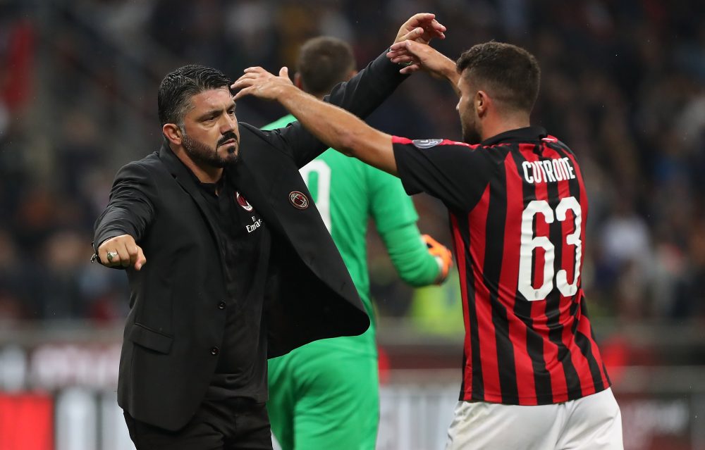 MILAN, ITALY - AUGUST 31: AC Milan coach Gennaro Gattuso (L) celebrates victory with Patrick Cutrone (R) at the end of the serie A match between AC Milan and AS Roma at Stadio Giuseppe Meazza on August 31, 2018 in Milan, Italy. (Photo by Marco Luzzani/Getty Images)