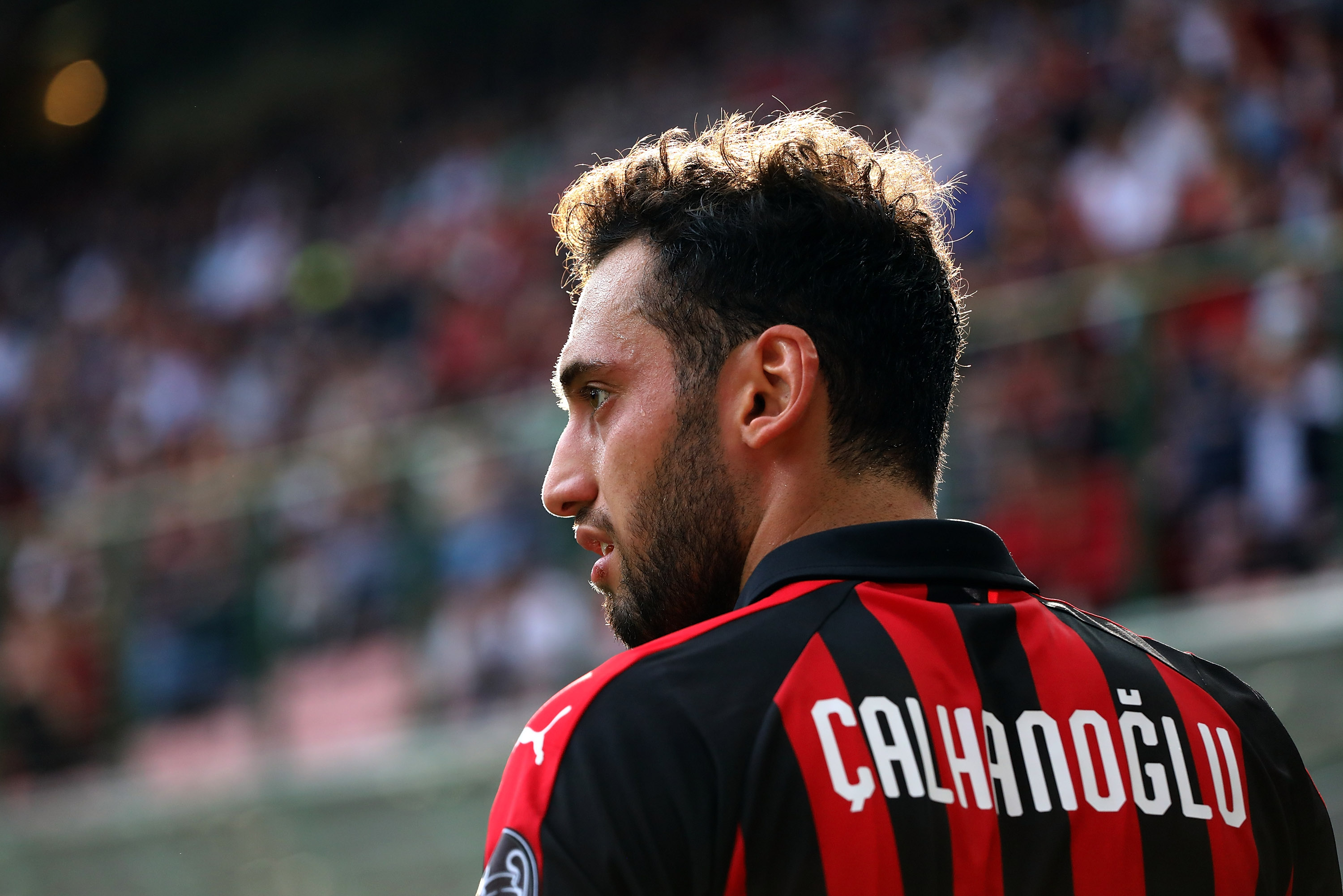 MILAN, ITALY - OCTOBER 07: Hakan Calhanoglu of AC Milan looks on during the Serie A match between AC Milan and Chievo Verona at Stadio Giuseppe Meazza on October 7, 2018 in Milan, Italy. (Photo by Marco Luzzani/Getty Images)