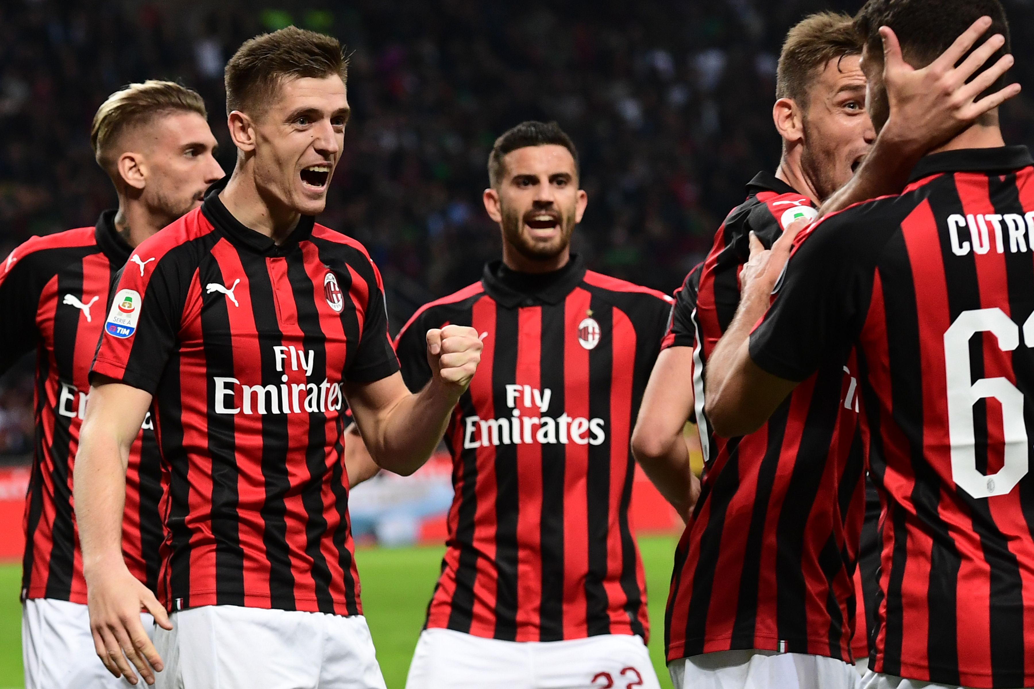 AC Milan's Polish forward Krzysztof Piatek (L) celebrates with teammates after opening the scoring during the Italian Serie A football march AC Milan vs Udinese on April 2, 2019 at the San Siro stadium in Milan. (Photo by Miguel MEDINA / AFP) (Photo credit should read MIGUEL MEDINA/AFP/Getty Images)
