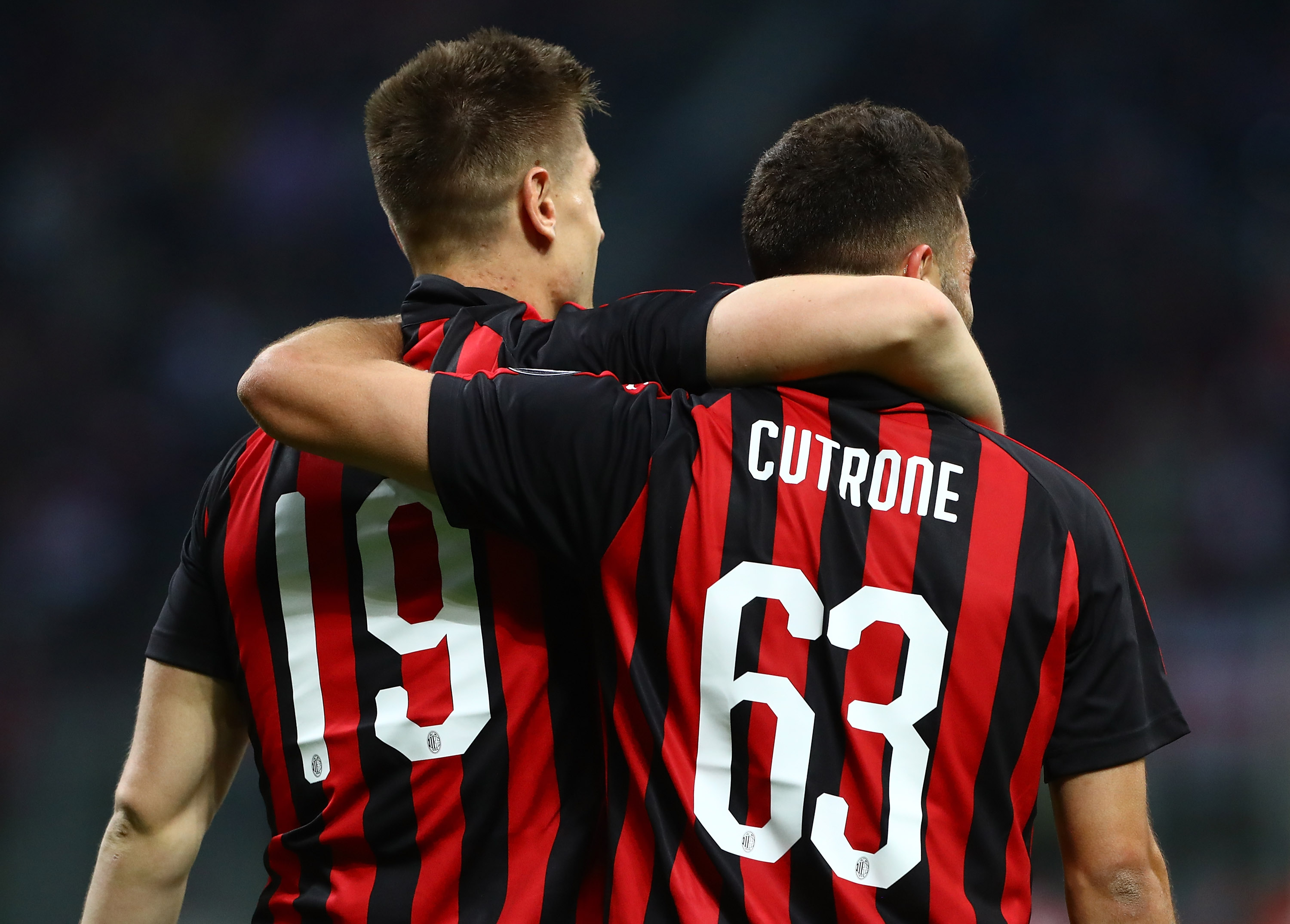 MILAN, ITALY - APRIL 02: Krzysztof Piatek (L) of AC Milan celebrates with his team-mate Patrick Cutrone (R) after scoring the opening goal during the Serie A match between AC Milan and Udinese at Stadio Giuseppe Meazza on April 2, 2019 in Milan, Italy. (Photo by Marco Luzzani/Getty Images)