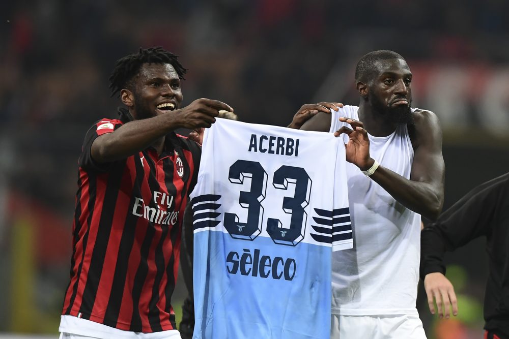 AC Milan's Ivorian midfielder Franck Kessie and AC Milan's French midfielder Tiemoue Bakayoko hold the jersey of Lazio's Italian defender Francesco Acerbi at the end of the Italian Serie A football match AC Milan vs Lazio Rome on April 13, 2019 at the San Siro stadium in Milan. (Photo by Miguel MEDINA / AFP) (Photo credit should read MIGUEL MEDINA/AFP/Getty Images)