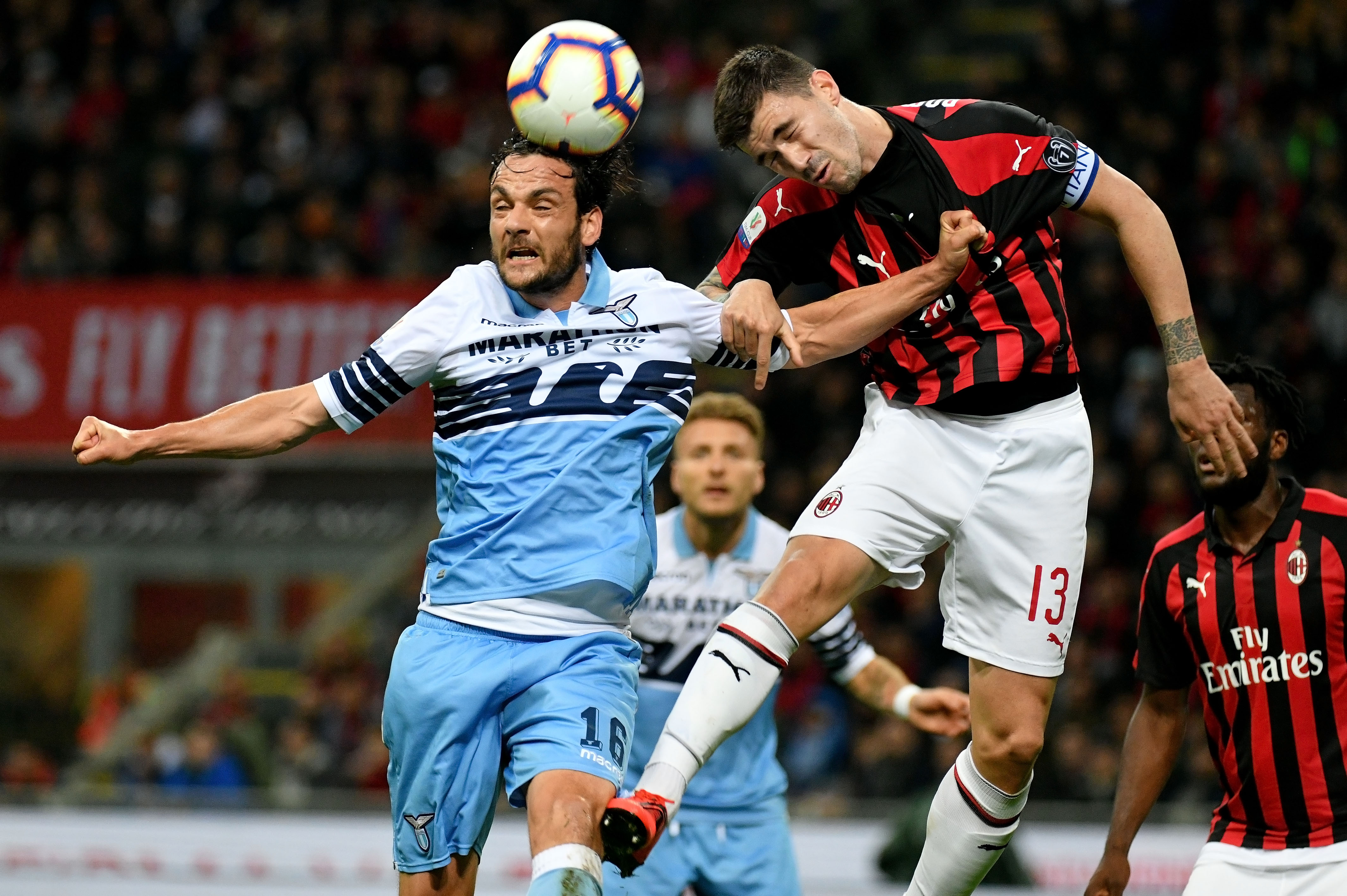 MILAN, ITALY - APRIL 24:  Alessio Romagnoli of AC Milan compete for the ball with Marco Parolo of SS Lazio during the TIM Cup match between AC Milan and SS Lazio at Stadio Giuseppe Meazza on April 24, 2019 in Milan, Italy.  (Photo by Marco Rosi/Getty Images)