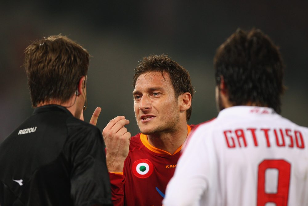 ROME - MARCH 15: Francesco Totti (centre) of Roma argues with the referee as Gennaro Gattuso (right) of Milan looks on during the Serie A match between Roma and AC Milan at the Olympic Stadium on March 15, 2008 in Rome, Italy. (Photo by Michael Steele/Getty Images)