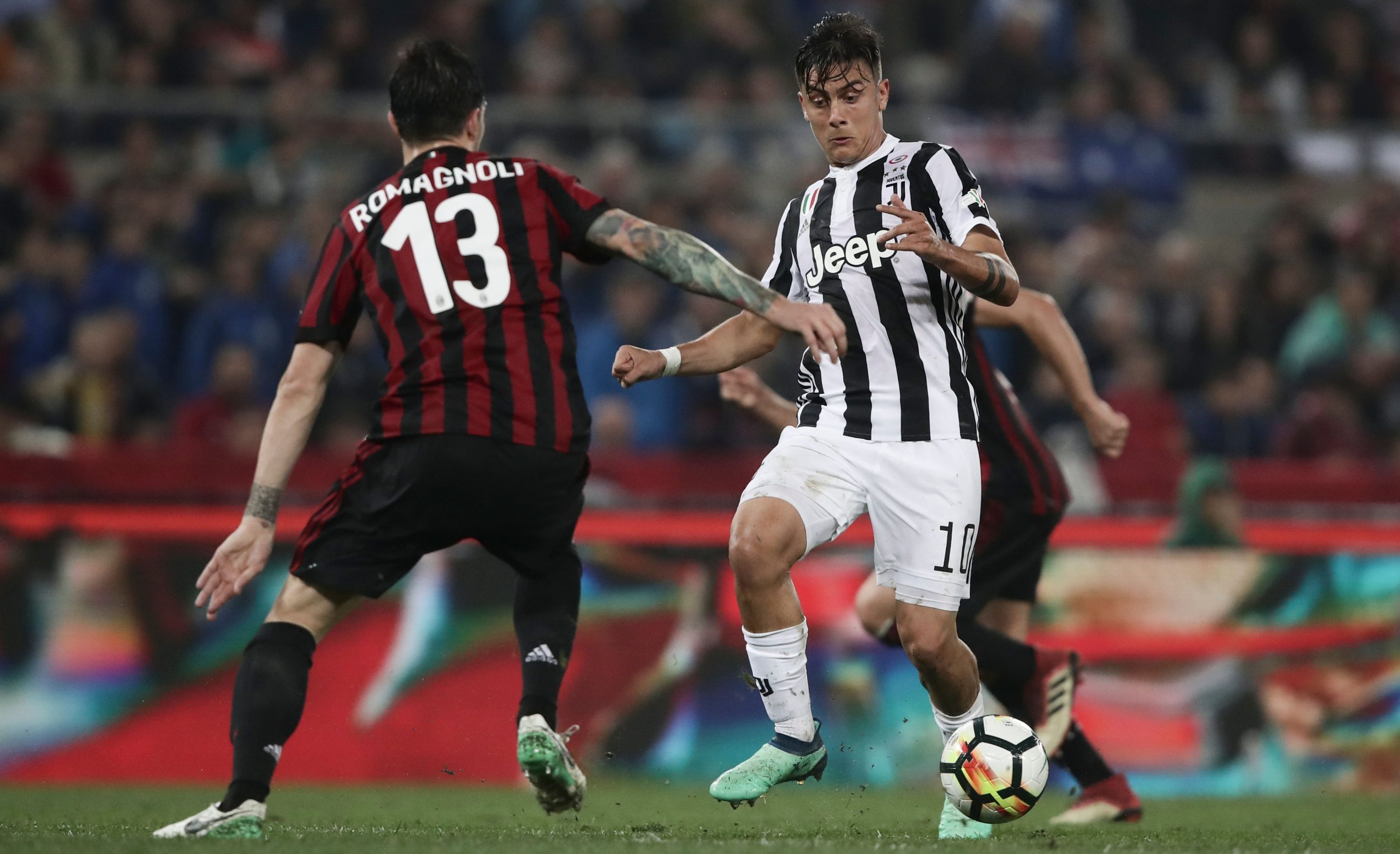 Juventus' forward from Argentina Paulo Dybala (R) vies with AC Milan's defender from Italy Alessio Romagnoli during the Italian Tim Cup (Coppa Italia) final Juventus vs AC Milan at the Olympic stadium on May 9, 2018 in Rome. (Photo by Isabella BONOTTO / AFP) (Photo credit should read ISABELLA BONOTTO/AFP/Getty Images)