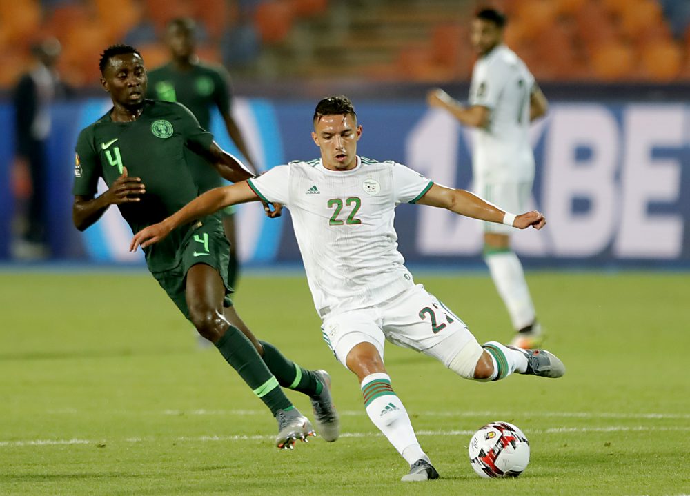 Algeria's midfielder Ismail Bennacer crosses the ball as he is marked by Nigeria's midfielder Wilfred Ndidi (L) during the 2019 Africa Cup of Nations (CAN) Semi-final football match between Algeria and Nigeria at the Cairo International stadium in Cairo on July 14, 2019. (Photo by FADEL SENNA / AFP) (Photo credit should read FADEL SENNA/AFP/Getty Images)