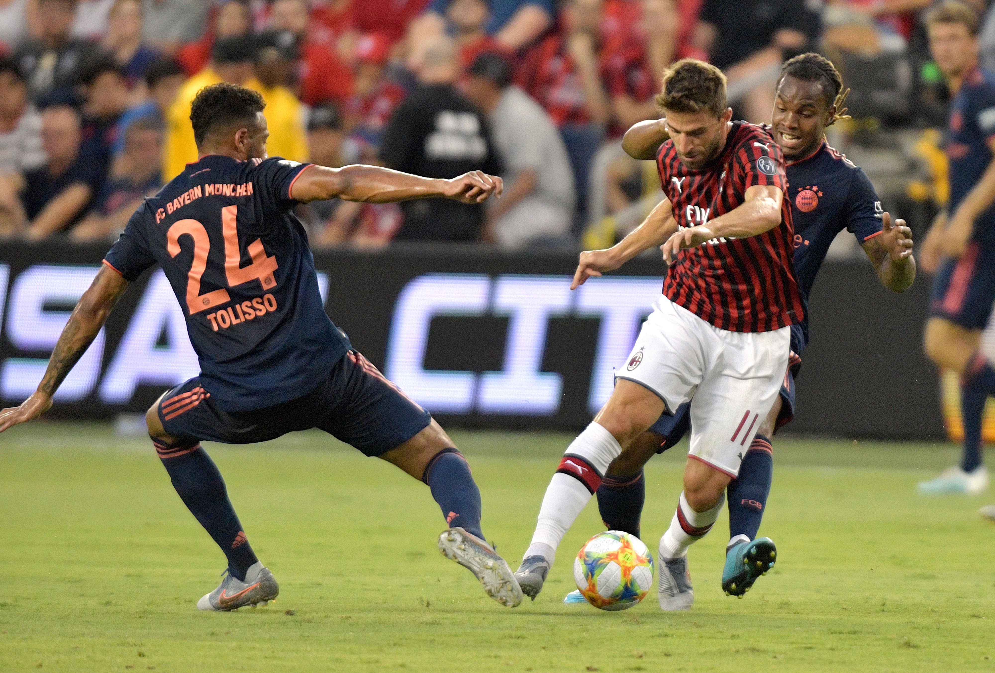 Bayern Munich's French midfielder Corentin Tolisso (L) and Portuguese midfileder Renato Sanches (R) vie for the ball with AC Milan's Italian foward Fabio Borini (C) during their International Champions Cup football match between Fc Bayern and AC Milan at Children's Mercy Park in Kansas City, Missouri on July 23, 2019. (Photo by Tim VIZER / AFP) (Photo credit should read TIM VIZER/AFP/Getty Images)