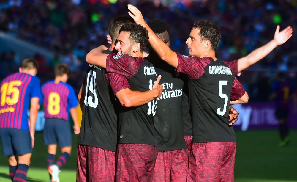 Andre Silva (L) of AC Milan celebrates with teammates including Hakan Calhanoglu (C) and Giacomo Bonaventura after scoring an injury time winner during the International Champions Cup (ICC) friendly football match between Barcelona and AC Milan in Santa Clara, California, on August 4, 2018. (Photo by Frederic J. BROWN / AFP) (Photo credit should read FREDERIC J. BROWN/AFP/Getty Images)