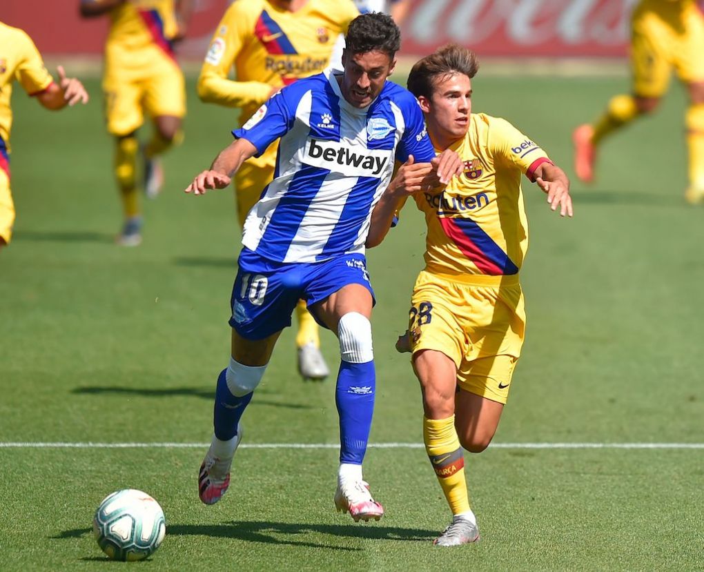 Barcelona's Spanish midfielder Riqui Puig (R) vies with Alaves' Swedish forward John Guidetti during the Spanish league football match between Deportivo Alaves and FC Barcelona at the Mendizorroza stadium in Vitoria on July 19, 2020. (Photo by ANDER GILLENEA / AFP) (Photo by ANDER GILLENEA/AFP via Getty Images)