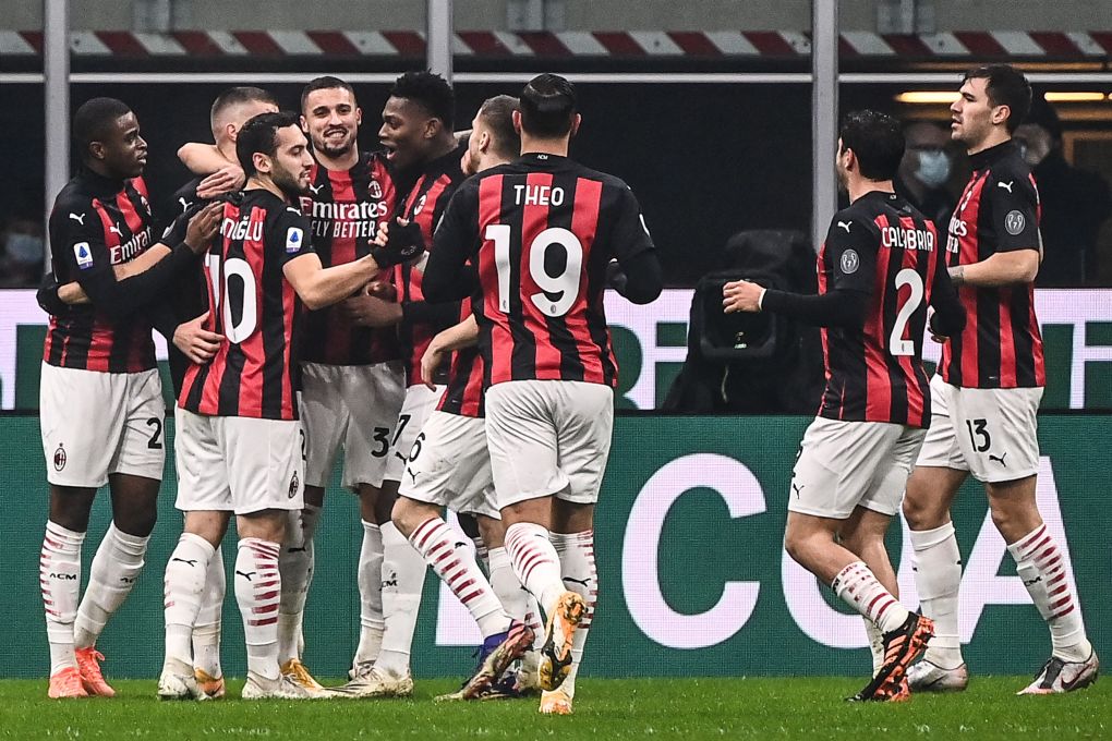 AC Milan's players celebrate after AC Milan's Croatian forward Ante Rebic (2ndL Rear) opened the scoring during the Italian Serie A football match AC Milan vs Lazio Rome on December 23, 2020 at the San Siro stadium in Milan. (Photo by Marco BERTORELLO / AFP) (Photo by MARCO BERTORELLO/AFP via Getty Images)