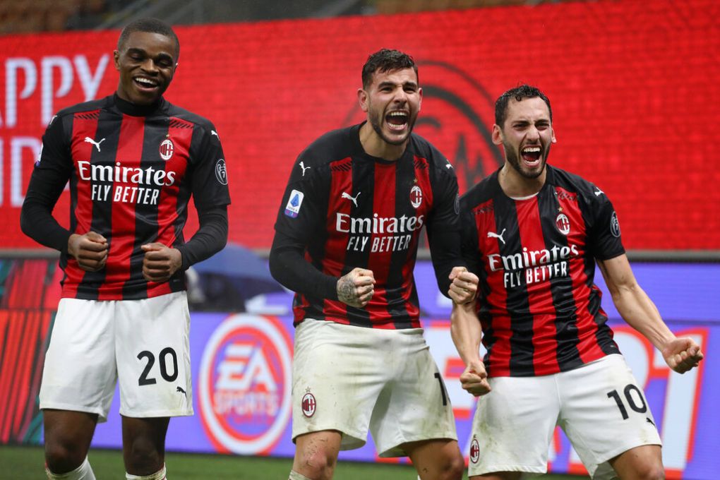 MILAN, ITALY - DECEMBER 23: Theo Hernandez (c) of AC Milan celebrates with team mates (l - r) Pierre Kalulu and Hakan Calhanoglu after scoring their sides third goal during the Serie A match between AC Milan and SS Lazio at Stadio Giuseppe Meazza on December 23, 2020 in Milan, Italy. Sporting stadiums around Italy remain under strict restrictions due to the Coronavirus Pandemic as Government social distancing laws prohibit fans inside venues resulting in games being played behind closed doors. (Photo by Marco Luzzani/Getty Images)