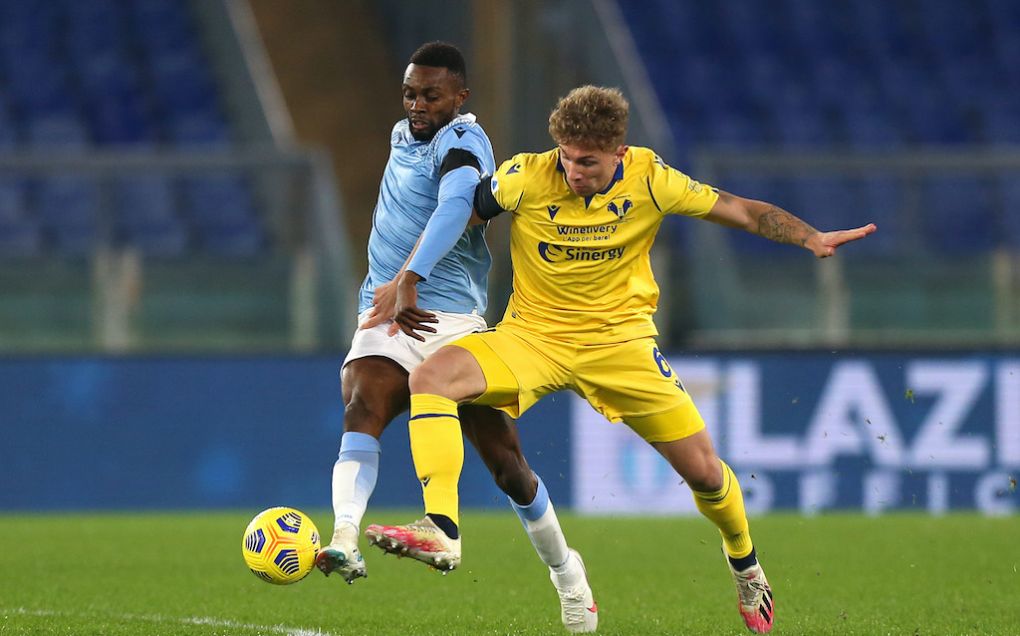 ROME, ITALY - DECEMBER 12: Jean-Daniel Akpa Akpro battles for possession with Matteo Lovato of Hellas Verona F.C. during the Serie A match between SS Lazio and Hellas Verona FC at Stadio Olimpico on December 12, 2020 in Rome, Italy. Sporting stadiums around Italy remain under strict restrictions due to the Coronavirus Pandemic as Government social distancing laws prohibit fans inside venues resulting in games being played behind closed doors. (Photo by Paolo Bruno/Getty Images)