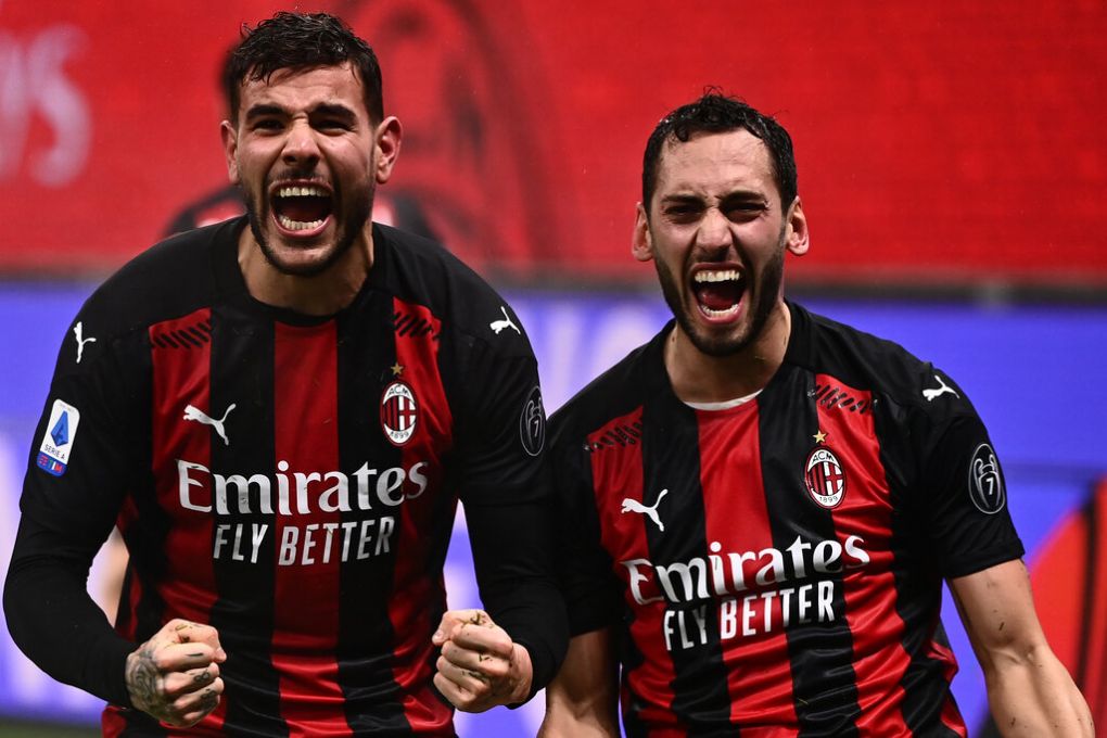 AC Milan's French defender Theo Hernandez (L) celebrates with AC Milan's Turkish midfielder Hakan Calhanoglu after scoring during the Italian Serie A football match AC Milan vs Lazio Rome on December 23, 2020 at the San Siro stadium in Milan. (Photo by Marco BERTORELLO / AFP) (Photo by MARCO BERTORELLO/AFP via Getty Images)