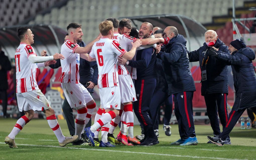 BELGRADE, SERBIA - FEBRUARY 18: Guelor Kanga of Crvena Zvezda (C) celebrates after scoring their sides first goal with Dejan Stankovic, manager of Crvena Zvezda during the UEFA Europa League Round of 32 match between Crvena Zvezda and AC Milan at Rajko Mitic Stadium on February 18, 2021 in Belgrade, Serbia. Sporting stadiums around Serbia remain under strict restrictions due to the Coronavirus Pandemic as Government social distancing laws prohibit fans inside venues resulting in games being played behind closed doors. (Photo by Srdjan Stevanovic/Getty Images)