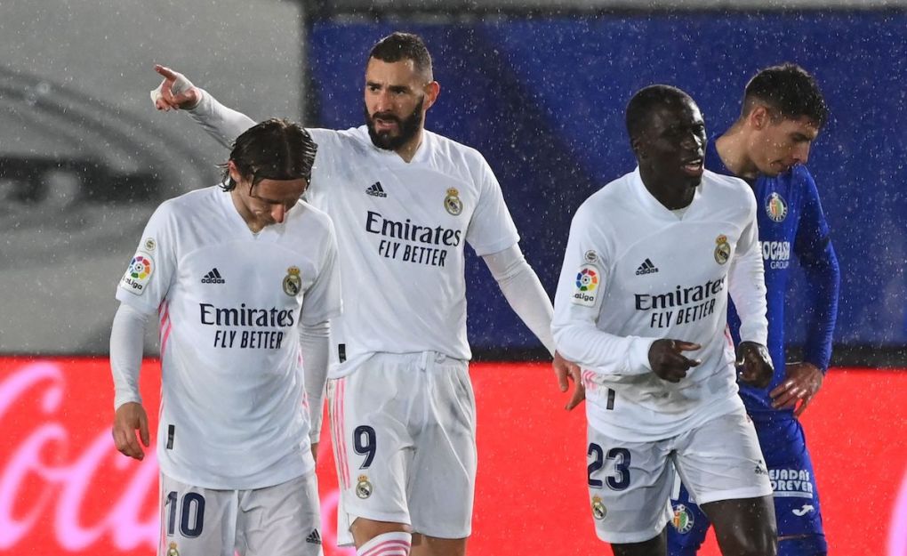 Real Madrid's French forward Karim Benzema (2R) celebrates after scoring a goal during the Spanish league football match between Real Madrid CF and Getafe CF at the Alfredo di Stefano stadium in Valdebebas, on the outskirts of Madrid on February 9, 2021. (Photo by GABRIEL BOUYS / AFP) (Photo by GABRIEL BOUYS/AFP via Getty Images)