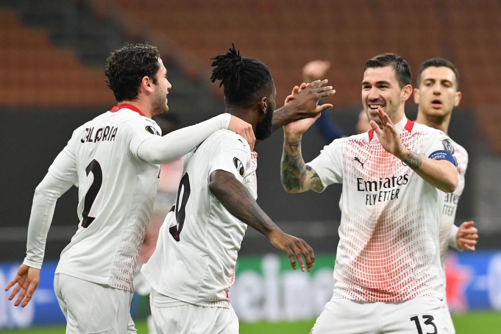 AC Milan's Ivorian midfielder Franck Kessie (C) celebrates with AC Milan's Italian defender Davide Calabria (L) and AC Milan's Italian defender Alessio Romagnoli after opening the scoring during the UEFA Europa League round of 32, 2nd leg football match AC Milan vs Crvena Zvezda on February 25, 2021 at the San Siro stadium in Milan. (Photo by Tiziana FABI / AFP) (Photo by TIZIANA FABI/AFP via Getty Images)