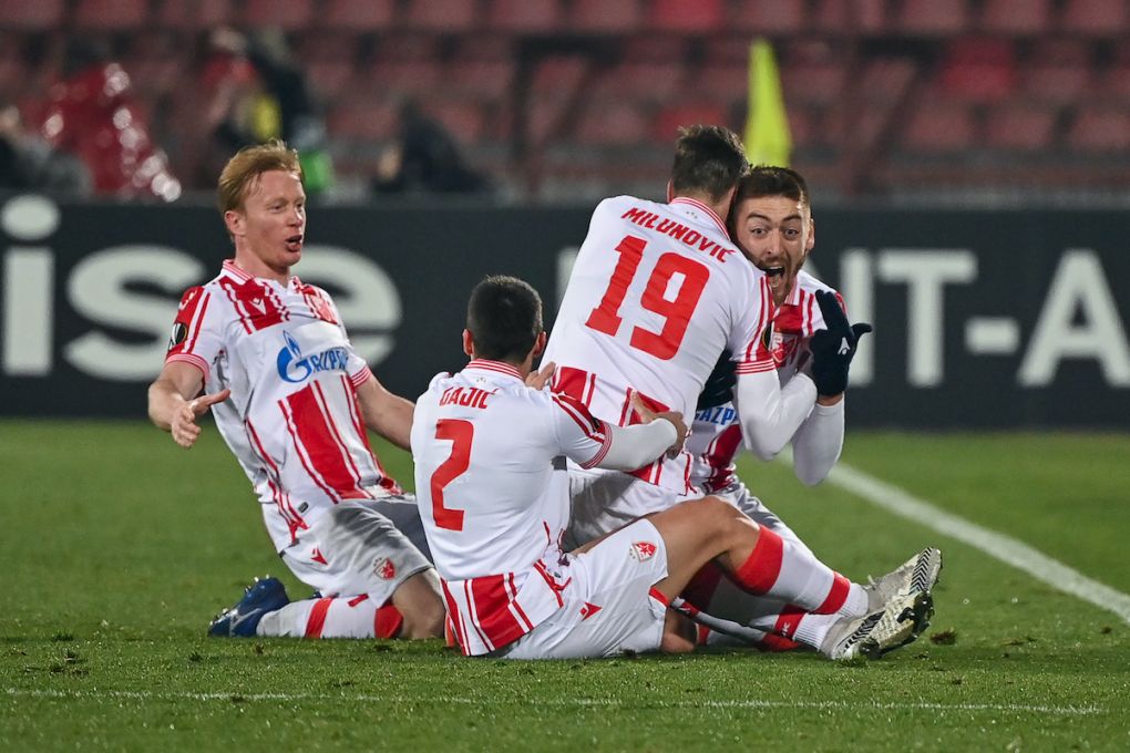 Crvena Zvezda Beograd's Serbian forward Milan Pavkov (R) celebrates with teammates after scoring a goal during the UEFA Europa League round of 32 football match between Crvena Zvezda Beograd (Red Star Belgrade) and AC Milan at the Rajko Mitic stadium in Belgrade, on February 18, 2021. (Photo by ANDREJ ISAKOVIC / AFP) (Photo by ANDREJ ISAKOVIC/AFP via Getty Images)