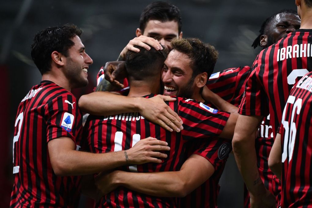 AC Milan's Algerian midfielder Ismael Bennacer (2nd L) celebrates with AC Milan's Turkish midfielder Hakan Calhanoglu (C) after scoring a goal during the Italian Serie A football match AC Milan vs Bologna played behind closed doors on July 15, 2020 at the San Siro Stadium in Milan, as the country eases its lockdown aimed at curbing the spread of the COVID-19 infection, caused by the novel coronavirus. (Photo by MARCO BERTORELLO / AFP) (Photo by MARCO BERTORELLO/AFP via Getty Images)