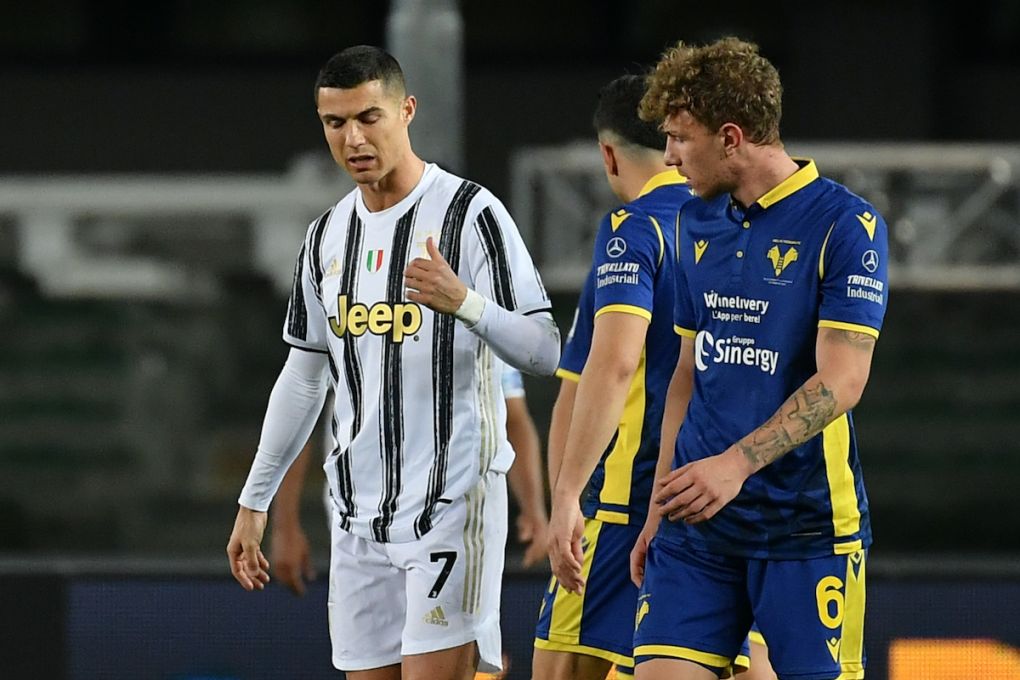 Juventus' Portuguese forward Cristiano Ronaldo (L) reacts next to Hellas Verona's Italian defender Matteo Lovato at the end of the Italian Serie A football match Hellas Verona vs Juventus Turin on February 27, 2021 at the Marcantonio-Bentegodi stadium in Verona. (Photo by Isabella BONOTTO / AFP) (Photo by ISABELLA BONOTTO/AFP via Getty Images)