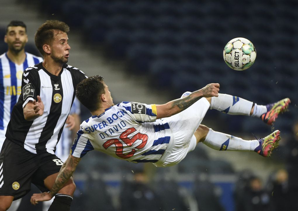 FC Porto's Brazilian midfielder Otavio (R) kicks the ball next to Nacional's Portuguese midfielder Francisco Ramos during the Portuguese league football match between FC Porto and CD Nacional Madeira at the Dragao stadium in Porto on December 20, 2020. (Photo by MIGUEL RIOPA / AFP) (Photo by MIGUEL RIOPA/AFP via Getty Images)
