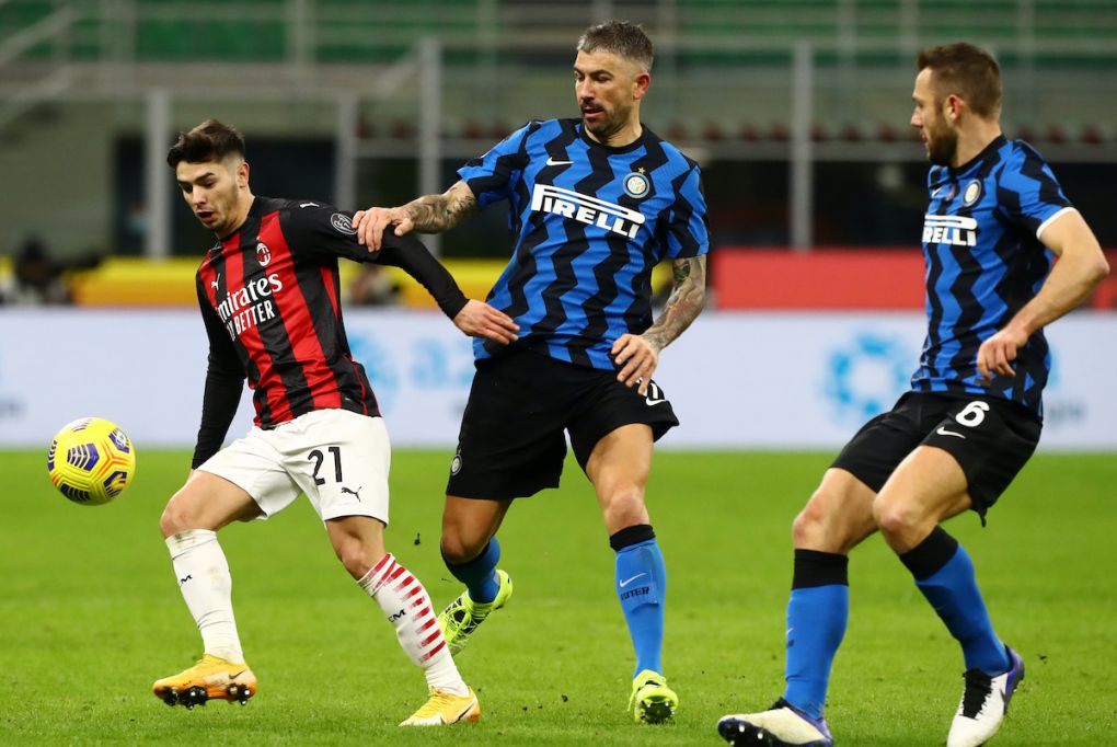 MILAN, ITALY - JANUARY 26: Brahim Diaz of Milan is challenged by Aleksandar Kolarov of Internazionale during the Coppa Italia match between FC Internazionale and AC Milan at Stadio Giuseppe Meazza on January 26, 2021 in Milan, Italy. Sporting stadiums around Italy remain under strict restrictions due to the Coronavirus Pandemic as Government social distancing laws prohibit fans inside venues resulting in games being played behind closed doors. (Photo by Marco Luzzani/Getty Images)