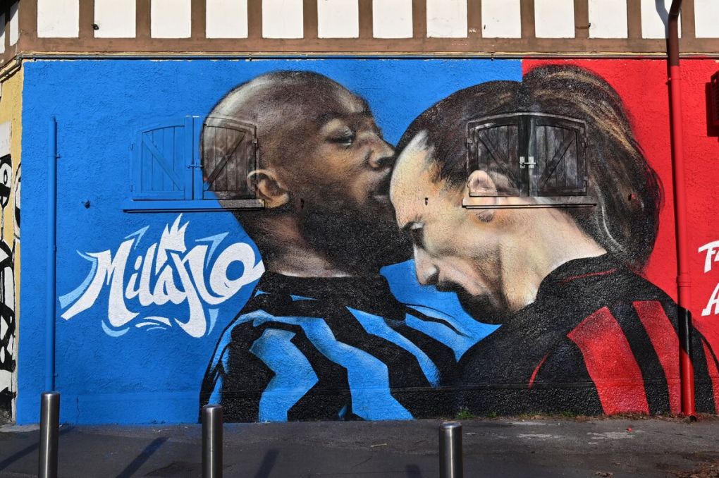 A picture taken in Milan on February 15, 2021 shows a street art mural by an unknown artist on a wall near the San Siro stadium, depicting AC Milan's Swedish forward Zlatan Ibrahimovic headbutting Inter Milan's Belgian forward Romelu Lukaku, a gesture that occured last January 26 during their Italian Cup quarter final match. (Photo by MIGUEL MEDINA / AFP) / RESTRICTED TO EDITORIAL USE - MANDATORY MENTION OF THE ARTIST UPON PUBLICATION - TO ILLUSTRATE THE EVENT AS SPECIFIED IN THE CAPTION (Photo by MIGUEL MEDINA/AFP via Getty Images)