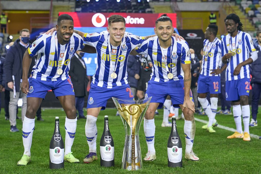 AVEIRO, PORTUGAL - DECEMBER 23: Wilson Manafa, Otavio Edmilson da Silva and Jesus Corona of FC Porto pose with Candido de Oliveira trophy following his sides victory during the Portuguese Super Cup match between FC Porto and SL Benfica at Estadio Municipal de Aveiro on December 23, 2020 in Aveiro, Portugal. Sporting stadiums around Portugal remain under strict restrictions due to the Coronavirus Pandemic as Government social distancing laws prohibit fans inside venues resulting in games being played behind closed doors. (Photo by Jose Manuel Alvarez/Quality Sport Images/Getty Images)