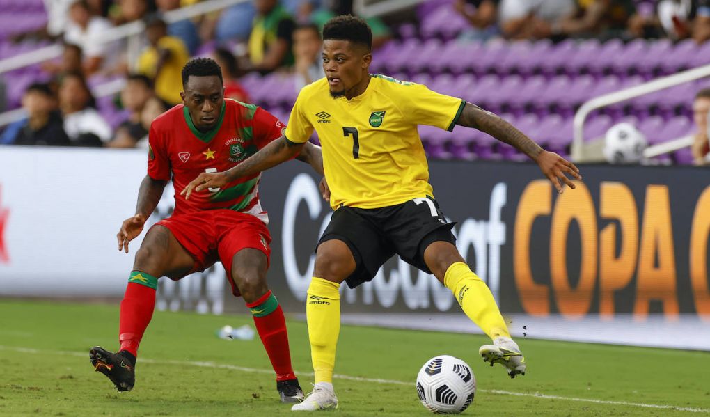 ORLANDO, FL - JULY 12: Jamaica forward Leon Bailey 7 passes the ball on front of Suriname defender Ridgeciano Haps 5 during a Concacaf Gold Cup match between Jamaica and Suriname on July 12, 2021 at Exploria Stadium in Orlando, Fl. Photo by David Rosenblum/Icon Sportswire SOCCER: JUL 12 Concacaf Gold Cup - Jamaica v Suriname Icon21071210638