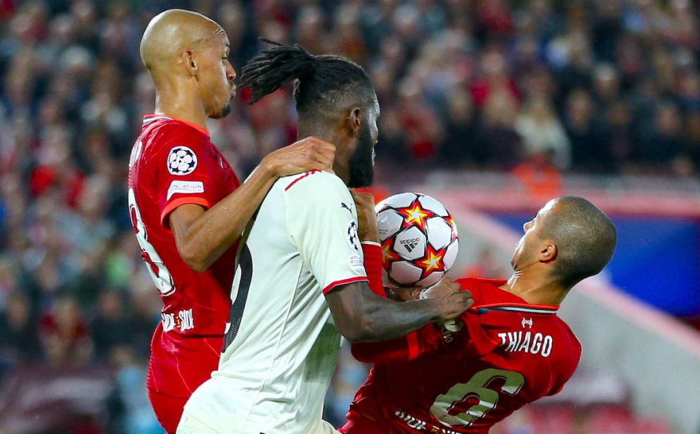 Franck Kessie AC Milan fights for the ball with Fabinho Liverpool FC and Thiago Alcantara