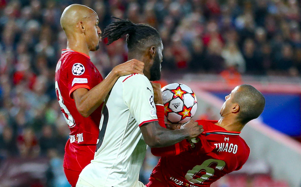 Franck Kessie AC Milan fights for the ball with Fabinho Liverpool FC and Thiago Alcantara 