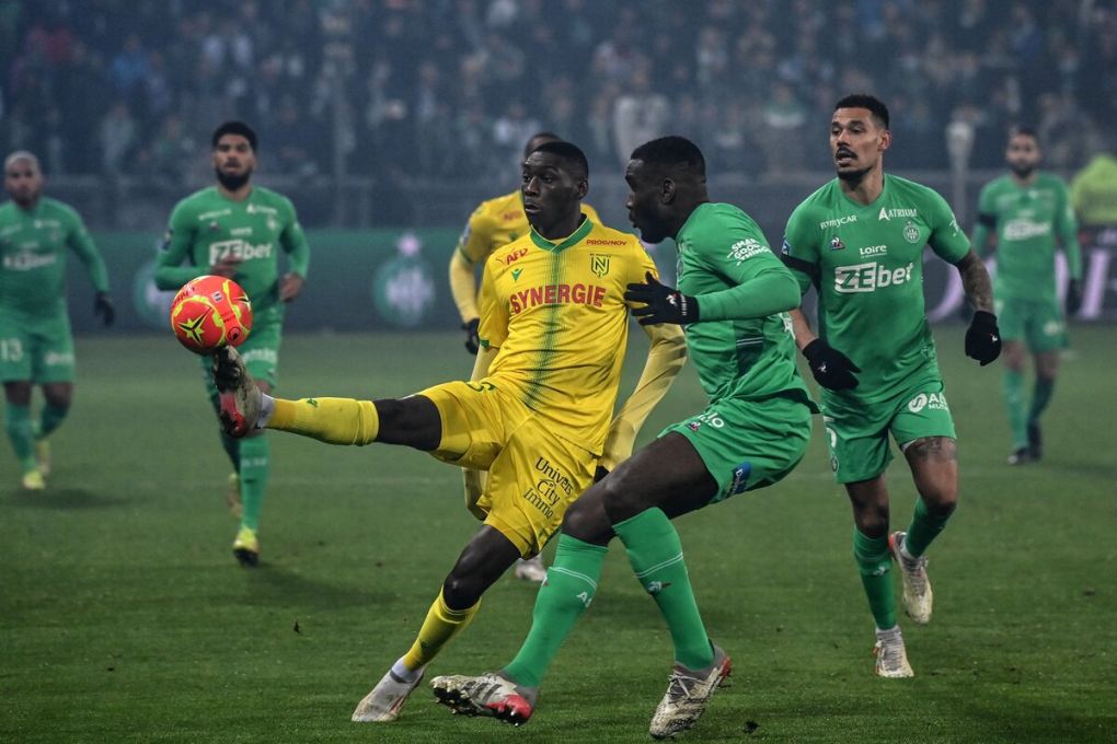 Nantes French forward Randal Kolo Muani (C) fights for the ball with Saint-Etiennes French defender Mickael Nadé during the French L1 football match between AS Saint-Etienne and FC Nantes at the Geoffrey Guichard stadium Saint-Etienne, central France, on December 22, 2021. (Photo by OLIVIER CHASSIGNOLE / AFP) (Photo by OLIVIER CHASSIGNOLE/AFP via Getty Images)