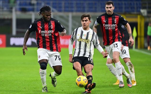 Juventus' Argentine forward Paulo Dybala (C) challenges AC Milan's Ivorian midfielder Franck Kessie