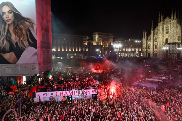 Supporters cheer as AC Milan players parade with the Scudetto Trophy