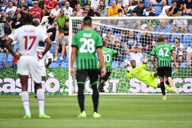 AC Milan's French goalkeeper Mike Maignan (Rear) deflects a penalty shot by Sassuolo's Italian forward Domenico Berardi (Rear L) during the Italian Serie A football match between Sassuolo and AC Milan, on August 30, 2022 at the Mapei stadium - Citta del Tricolore in Reggio Emilia. (Photo by Isabella BONOTTO / AFP) (Photo by ISABELLA BONOTTO/AFP via Getty Images)