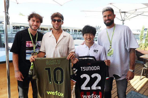 MONZA, ITALY - SEPTEMBER 11: Pierre Gasly of France and Scuderia AlphaTauri and Yuki Tsunoda of Japan and Scuderia AlphaTauri pose for a photo with Olivier Giroud and Davide Calabria prior to the F1 Grand Prix of Italy at Autodromo Nazionale Monza on September 11, 2022 in Monza, Italy. (Photo by Peter Fox/Getty Images)