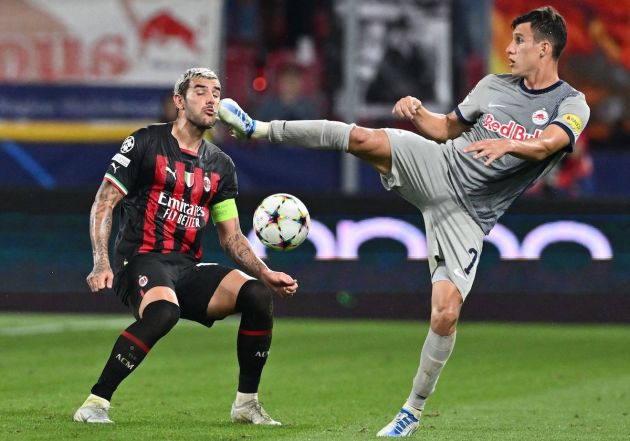 AC Milan's French defender Theo Hernandez (L) and Salzburg's Argentinian midfielder Nicolas Capaldo vie for the ball during the UEFA Champions League Group E football match FC Salzburg v AC Milan on September 6, 2022, in Salzburg, Austria. (Photo by JOE KLAMAR / AFP) (Photo by JOE KLAMAR/AFP via Getty Images)