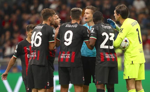 Referee Daniel Siebert disputes with AC Milan players