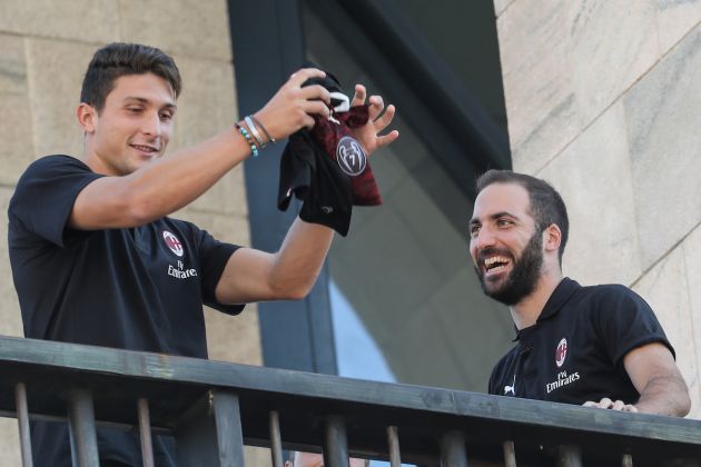 New AC Milan players Argentinian Gonzalo Higuain (R) and Italian Mattia Caldara