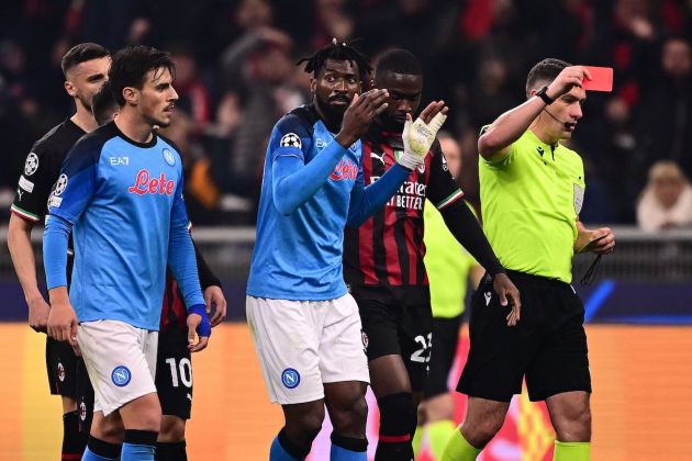 Romanian referee Istvan Kovacs (R) gives a red card to Napoli's Cameroonian midfielder Andre Zambo Anguissa