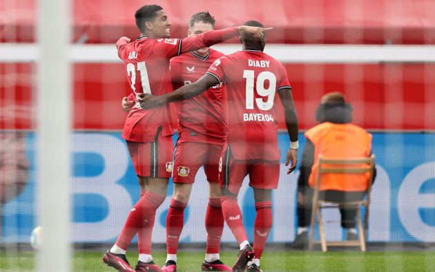 Amine Adli of Bayer 04 Leverkusen celebrates with teammates Florian Wirtz and Moussa Diaby