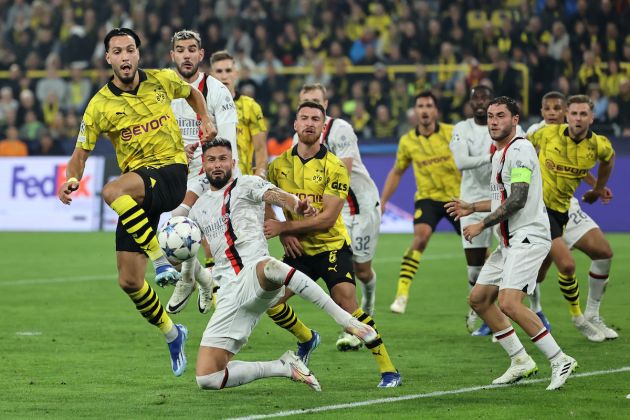 Ramy Bensebaini of Borussia Dortmund and Olivier Giroud of AC Milan