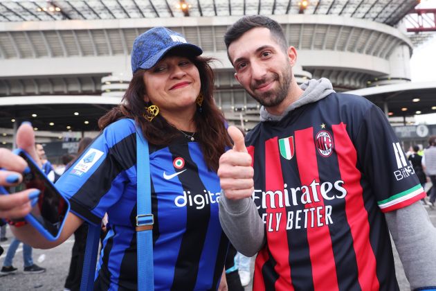 FC Internazionale fan poses for a photo with an AC Milan fan