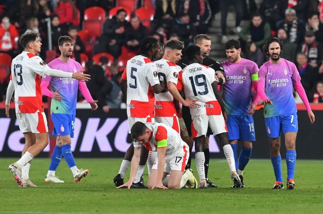 Slavia Prague's players argue with the referee