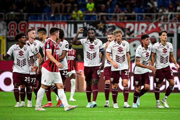 Torino's players celebrate after an own goal by AC Milan's German defender #28 Malick Thiaw