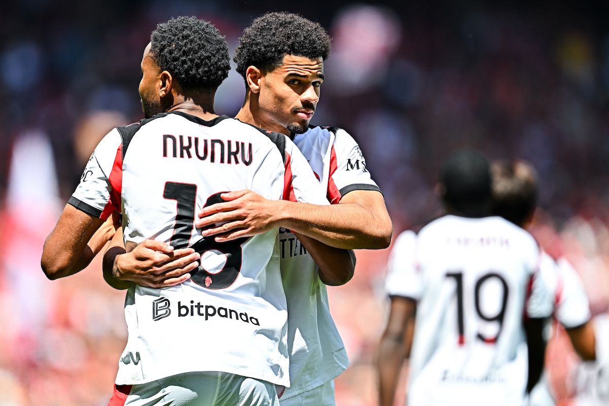 Christopher Nkunku of Milan (left) celebrates with his team-mate Zachary Athekame